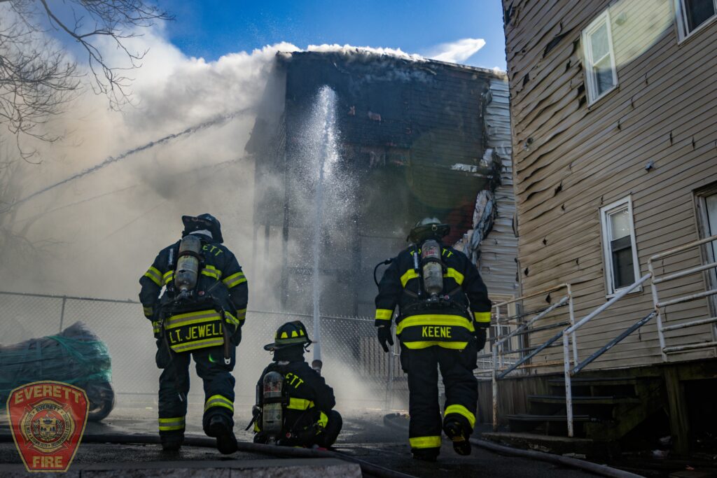 Everett Firefighters hosing down a house on fire